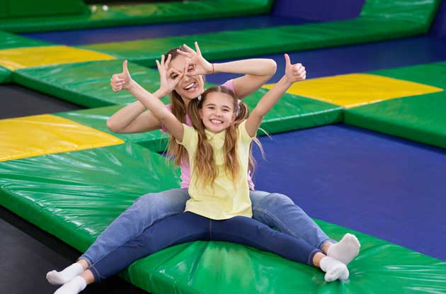 Mother and young daughter having fun in an indoor playground.
